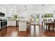 Modern kitchen with white cabinets, stainless steel appliances, and a breakfast bar that leads to the dining area at 2560 51St N St, St Petersburg, FL 33710