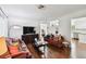 Spacious living room boasting hardwood floors, ample seating, and a modern entertainment center at 2560 51St N St, St Petersburg, FL 33710