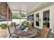 Charming screened-in patio with a dining table, comfortable seating, and views of the backyard at 2560 51St N St, St Petersburg, FL 33710