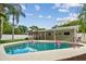 Backyard pool with putting green and outdoor bar, surrounded by lush landscaping at 2560 51St N St, St Petersburg, FL 33710