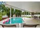 Backyard pool and patio area with lounge chairs and tropical landscaping at 2560 51St N St, St Petersburg, FL 33710