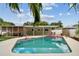 Backyard pool with pink flamingo floaties, adjacent to the lanai, putting green and lush landscaping at 2560 51St N St, St Petersburg, FL 33710
