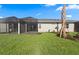 Expansive backyard featuring a screened-in lanai and well-manicured lawn at 27132 Capri Shores Cir, Englewood, FL 34223
