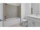 Clean, neutral bathroom features a bathtub and shower combination at 27132 Capri Shores Cir, Englewood, FL 34223