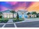 Inviting community clubhouse exterior with palm trees and colorful sunset at 27132 Capri Shores Cir, Englewood, FL 34223