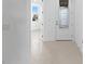 Bright foyer featuring a glass-paneled front door, neutral tile flooring and direct access to another room at 27132 Capri Shores Cir, Englewood, FL 34223