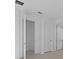 Hallway with neutral walls and tile flooring leads to multiple rooms at 27132 Capri Shores Cir, Englewood, FL 34223