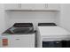 Convenient laundry room with new appliances and upper cabinet storage at 27132 Capri Shores Cir, Englewood, FL 34223