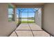 Screened patio with brick flooring provides scenic views of the lake at 27132 Capri Shores Cir, Englewood, FL 34223