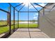 Stunning screened patio area showcasing serene lake views and lush landscaping at 27132 Capri Shores Cir, Englewood, FL 34223