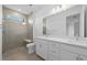 Bathroom featuring a double vanity, shower, and tile flooring at 27136 Capri Shores Cir, Englewood, FL 34223