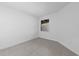 Bright bedroom featuring neutral walls, base molding, and gray tile flooring providing a clean, modern aesthetic at 27136 Capri Shores Cir, Englewood, FL 34223