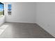 Bright bedroom with large window and tile flooring at 27136 Capri Shores Cir, Englewood, FL 34223