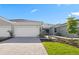 Charming home with a well-maintained lawn, brick driveway, and two-car garage at 27136 Capri Shores Cir, Englewood, FL 34223