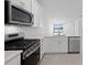 Modern kitchen with stainless steel appliances and a view of the water at 27136 Capri Shores Cir, Englewood, FL 34223