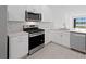 Beautiful kitchen with stainless steel appliances, white cabinets, and a view of the water at 27136 Capri Shores Cir, Englewood, FL 34223