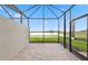 Lanai with pavers offering a serene view of the pond and natural surroundings with access to backyard at 27136 Capri Shores Cir, Englewood, FL 34223