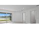 Living area with sliding glass doors leading to a patio with a lake view at 27136 Capri Shores Cir, Englewood, FL 34223