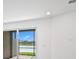 Bright living room with a sliding glass door and a view of the backyard lake at 27136 Capri Shores Cir, Englewood, FL 34223