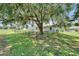 Spacious backyard featuring mature tree with Spanish moss, with a fenced-in area, providing privacy and shade at 2719 Wilder Trace Ct, Plant City, FL 33566