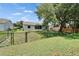 Fenced backyard with a screened-in patio, providing privacy and a peaceful outdoor living space at 2719 Wilder Trace Ct, Plant City, FL 33566