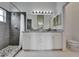 Modern bathroom with a double vanity, granite countertops, and a stylish tiled shower at 2719 Wilder Trace Ct, Plant City, FL 33566