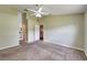 View of the spacious carpeted bedroom leading to an open doorway and a closet at 2719 Wilder Trace Ct, Plant City, FL 33566
