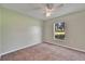 Bedroom featuring a ceiling fan, carpeted floor, and view of the backyard at 2719 Wilder Trace Ct, Plant City, FL 33566