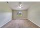 Bright bedroom featuring neutral walls, carpet flooring, and a window offering natural light and a ceiling fan at 2719 Wilder Trace Ct, Plant City, FL 33566