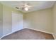 Neutral bedroom features carpet, a ceiling fan, and a closet for storage at 2719 Wilder Trace Ct, Plant City, FL 33566