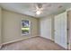 Bedroom with carpet, ceiling fan, natural light from the window and a closet with doors at 2719 Wilder Trace Ct, Plant City, FL 33566