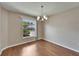 Bright dining room with wood floors, modern chandelier, and a large window view at 2719 Wilder Trace Ct, Plant City, FL 33566