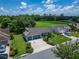 Aerial view of a well-maintained single-Gathering home with a three car garage and lush landscaping in a quiet neighborhood at 2719 Wilder Trace Ct, Plant City, FL 33566