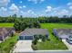 Aerial view of a well-maintained single-Gathering home with a three car garage and lush landscaping in a quiet neighborhood at 2719 Wilder Trace Ct, Plant City, FL 33566