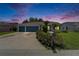 Charming home featuring a three-car garage, well-kept lawn, and lush landscaping at 2719 Wilder Trace Ct, Plant City, FL 33566