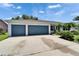 Three-car garage with ample parking space and well-maintained driveway at 2719 Wilder Trace Ct, Plant City, FL 33566