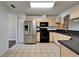 Eat-in kitchen featuring stainless steel refrigerator and tile flooring at 2719 Wilder Trace Ct, Plant City, FL 33566