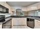 Kitchen featuring tile flooring, light colored cabinets and black appliances at 2719 Wilder Trace Ct, Plant City, FL 33566