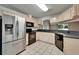 Kitchen featuring stainless steel refrigerator, black appliances, and light-colored cabinets at 2719 Wilder Trace Ct, Plant City, FL 33566