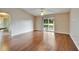 Spacious living room featuring wood floors, sliding glass doors to screened patio and lots of natural light at 2719 Wilder Trace Ct, Plant City, FL 33566