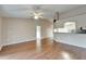 Bright living area with wood floors, ceiling fan, and view into the kitchen space at 2719 Wilder Trace Ct, Plant City, FL 33566