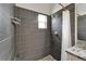 Sleek, tiled shower with a modern showerhead and pebble flooring detail at 2719 Wilder Trace Ct, Plant City, FL 33566