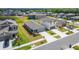 An aerial view shows a single story home with attached garage in a lakeside neighborhood at 3186 Oyster Cove St, Wimauma, FL 33598