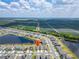 Aerial view showcasing a lakeside community near vast farmland at 3186 Oyster Cove St, Wimauma, FL 33598