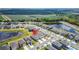 Aerial view of a lakeside community with a beautiful pond and farmlands in the distance at 3186 Oyster Cove St, Wimauma, FL 33598