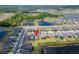 Real estate aerial of a neighborhood with nearby ponds and lush green forest, creating a peaceful and picturesque setting at 3186 Oyster Cove St, Wimauma, FL 33598