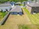 Backyard view of home with vinyl fence, grass, and patio at 3186 Oyster Cove St, Wimauma, FL 33598