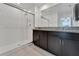 Bright bathroom featuring a walk-in shower, double granite vanity, and a sleek, contemporary design at 3186 Oyster Cove St, Wimauma, FL 33598