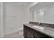 Clean bathroom with a dark vanity featuring a granite countertop, toilet, and shower with white tile at 3186 Oyster Cove St, Wimauma, FL 33598