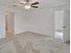 A spacious bedroom with neutral carpet and white walls with two doorways at 3186 Oyster Cove St, Wimauma, FL 33598